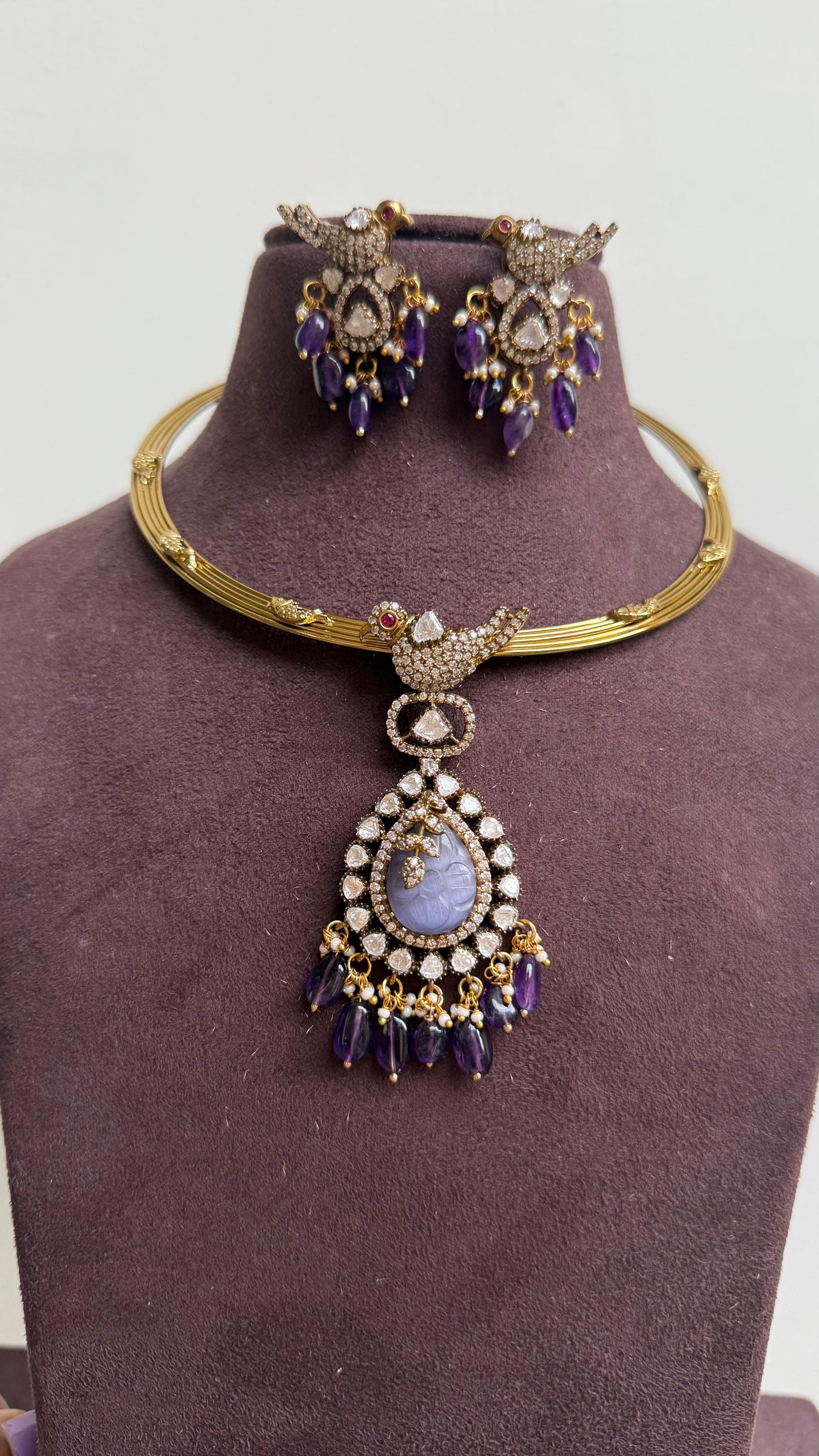 Parrot embossed hasli with locket and matching earrings