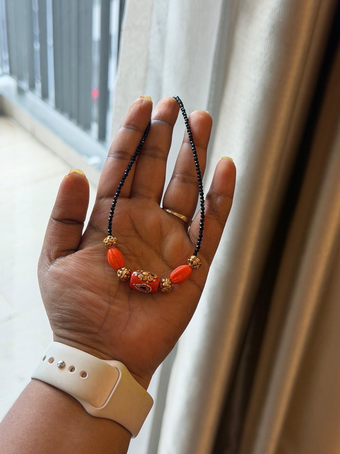 Three coral kundan gold balls black beads