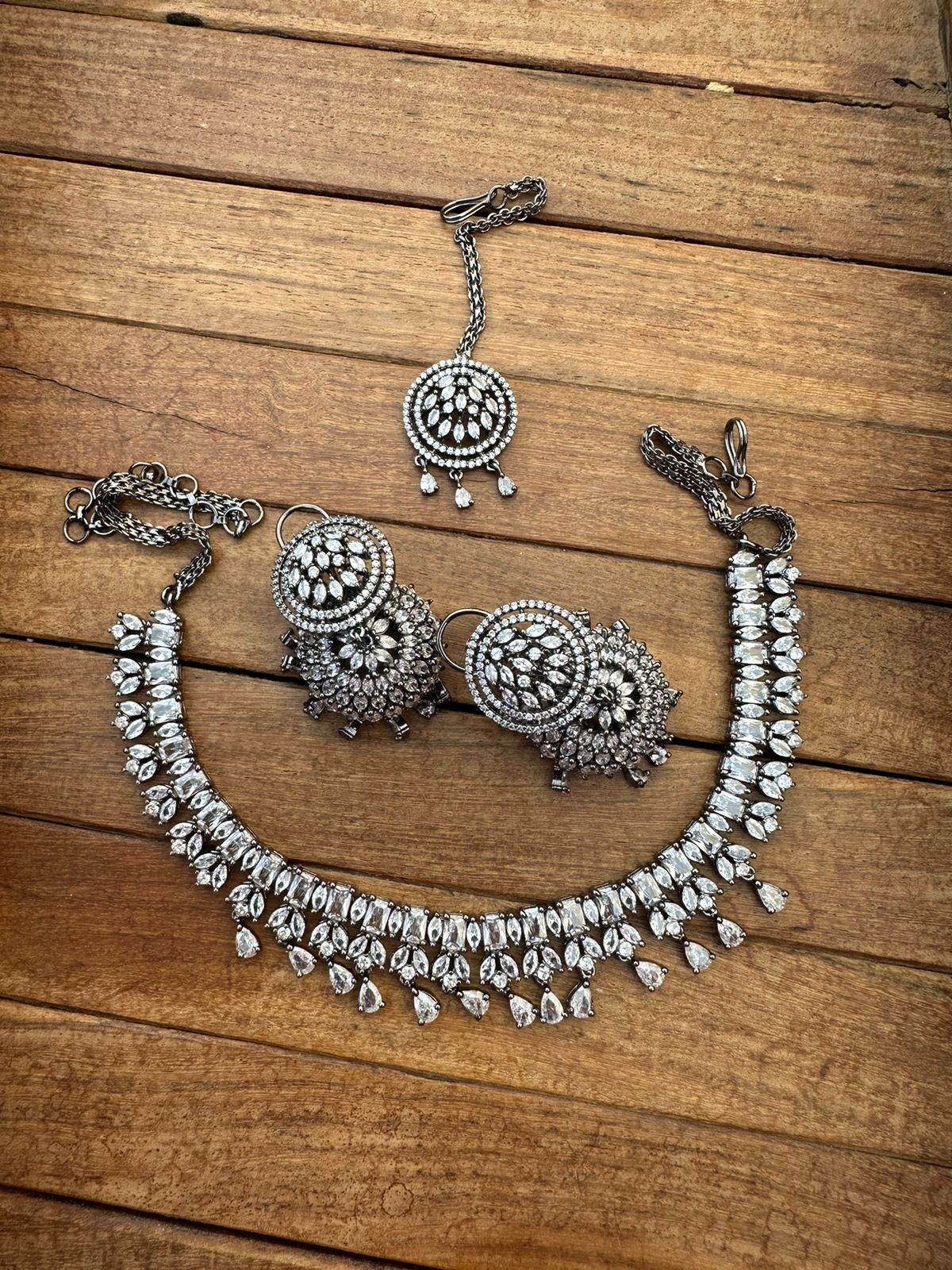Zircon necklace with revolving jhumkas and mangteeka - Alluring Accessories