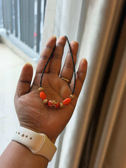 Three coral kundan gold balls black beads