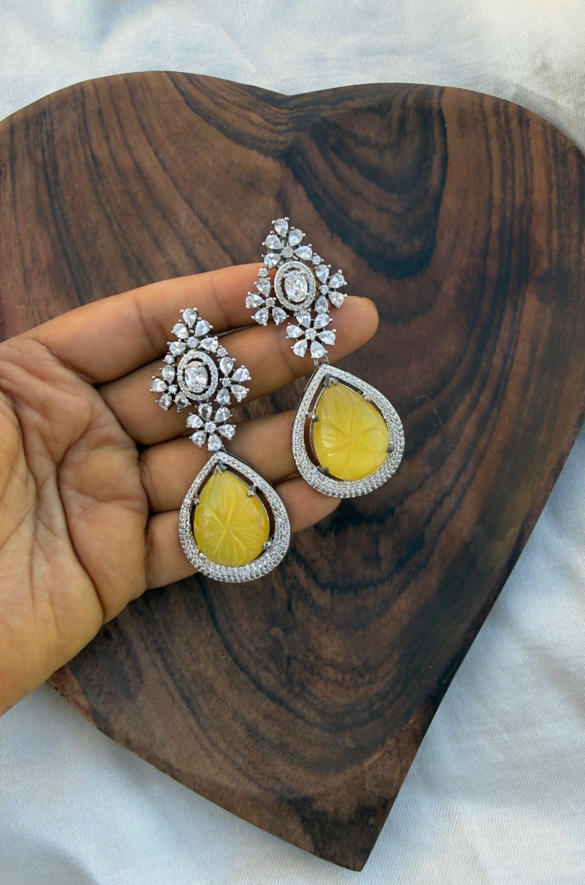 Statement diamond finish flower embossed yellow drop earrings