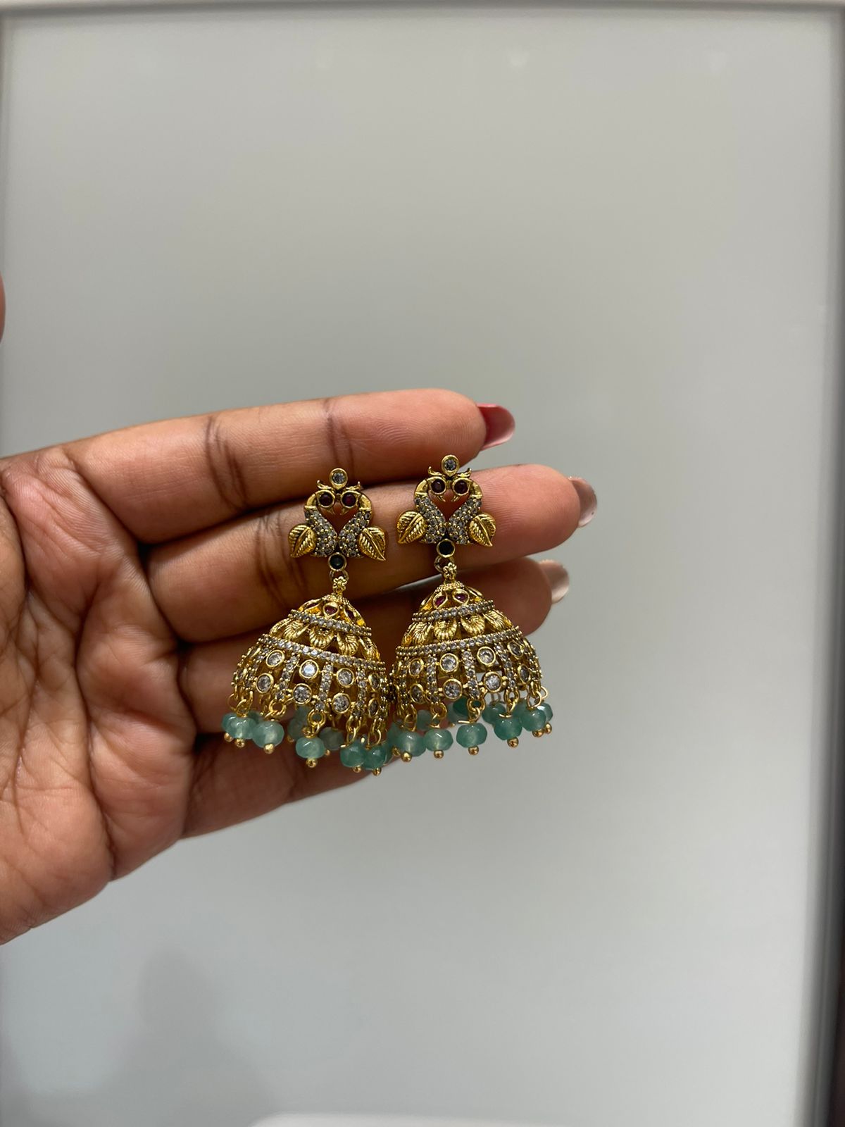 Dual peacock gold jhumkas - Alluring Accessories